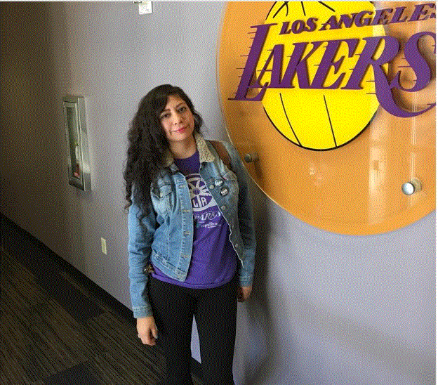 Woman standing by LA Lakers sign